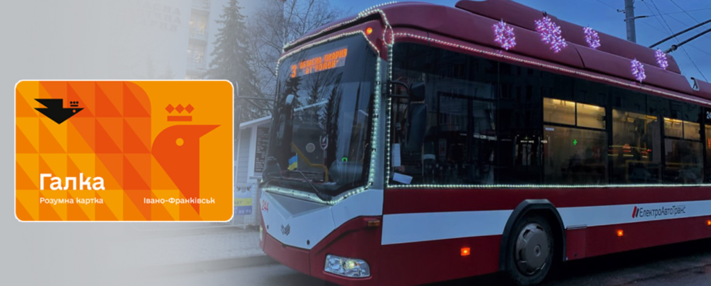 Процес оплати проїзду транспортною карткою «Галка» через жовтий валідатор у сучасному тролейбусі Івано-Франківська; крізь вікно видно місто.